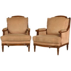 A pair of Louis XVI style walnut bergeres from France c.1890