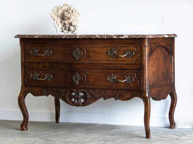 Receive our new selections direct from 1stdibs by email each week. Please click “Follow Dealer” button below and see them first!

An antique French Louis XV period walnut commode of elegant proportions circa 1760 with its original marble top. This