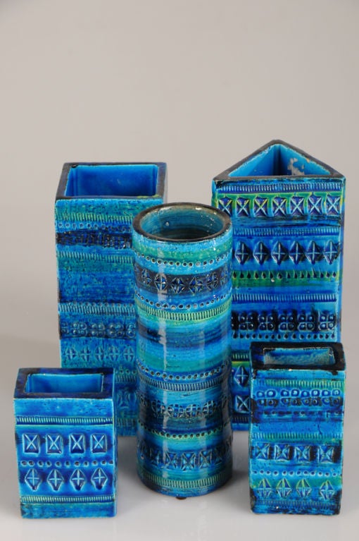 A collection of five assorted glazed earthenware vessels in a gorgeous blue and green from Italy c. 1965. Please notice the unusual variety of incised patterns present on each of these different shapes. The cylinder, the triangular shaped vessel,