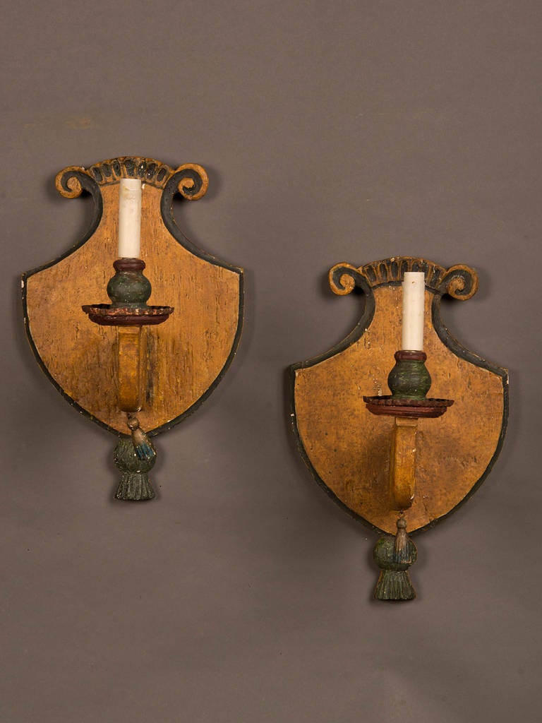 Receive our new selections direct from 1stdibs by email each week. Please click “Follow Dealer” button below and see them first!

A pair of antique Italian single arm wooden sconces circa 1870 each having its original painted finish. The shape of