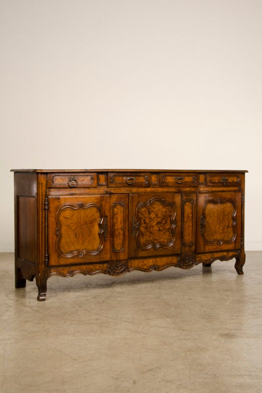 A superb Louis XV period walnut buffet/enfilade with characteristic motifs from the Regence period from France c.1770. Please notice the amazingly sensuous lines of this buffet/enfilade. A master cabinet maker succeeded in taking exceptional walnut