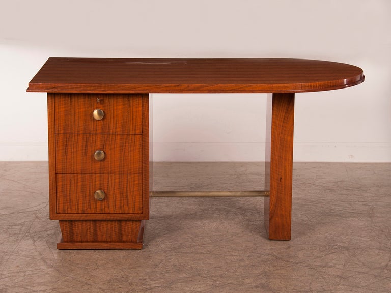 Receive our new selections direct from 1stdibs by email each week. Please click Follow Dealer below and see them first!

An Art Deco period French walnut desk with three drawers circa 1930. The clean geometric shape of this desk is enhnaced by the