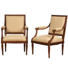 A pair of Louis XVI style walnut fauteuils from France c.1890