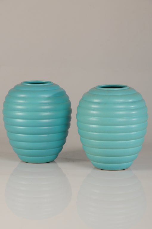 A striking pair of Art Deco period glazed earthenware vases from France c.1930. Please note the two distinguishing aspects of these vases that give them such decorative power-the shape and the colour. The overall form of these vases proceed directly