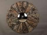 An enormous frame patinated zinc surrounding a convex mirror