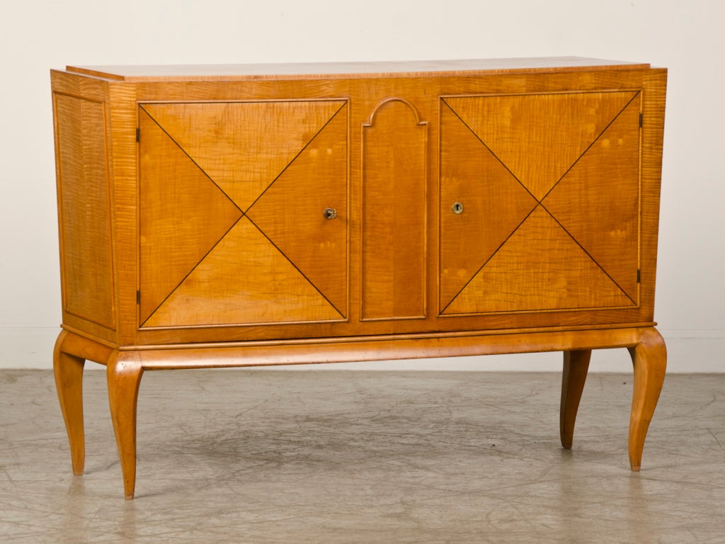 Receive our new selections direct from 1stdibs by email each week. Please click Follow Dealer below and see them first!

An Art Moderne period satinwood buffet  from France circa 1940 inspired by the exceptional Jules Leleu. The distinctive lines