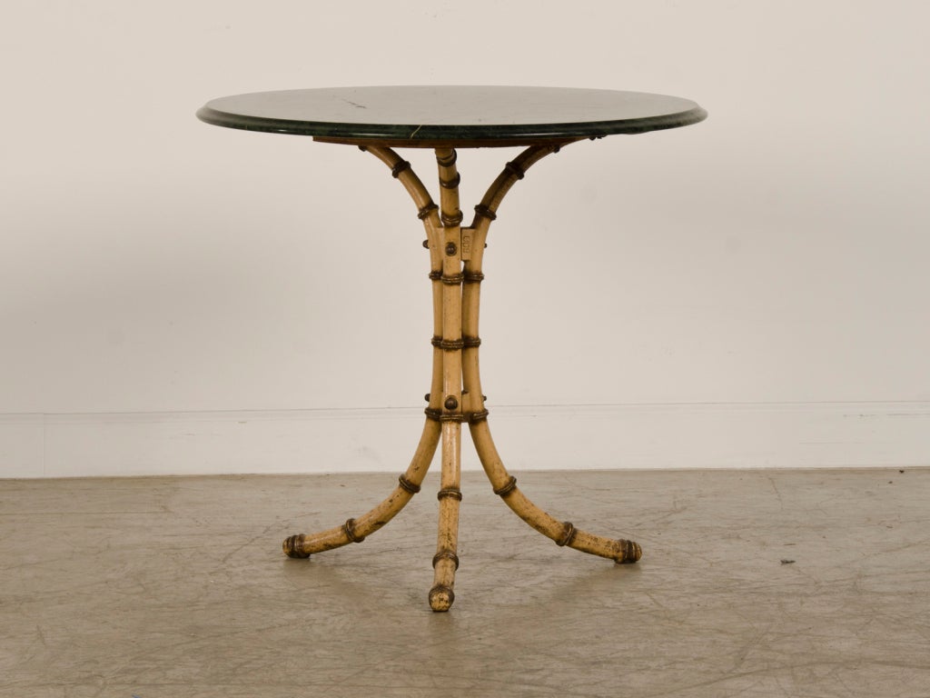 Painted cast iron faux bamboo table with a green marble top from Belle Epoque period France c.1890. This table was originally used in the orangerie (the winter glass house used to shelter tropical plants) of an estate near Montpelier, France. Please