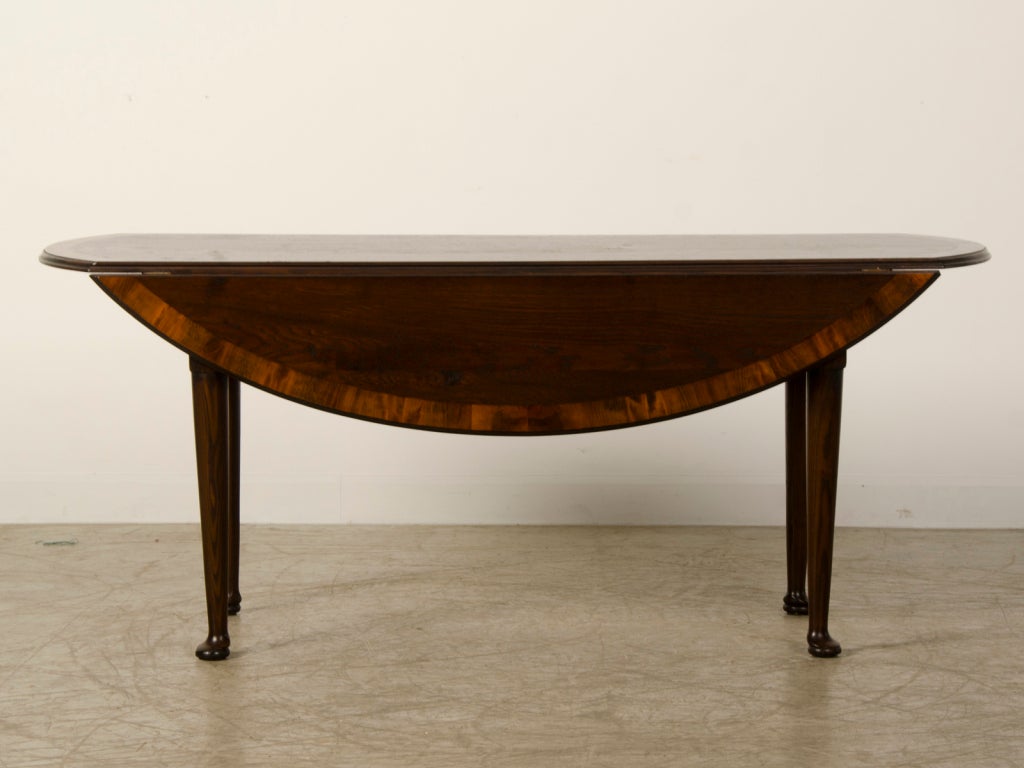 Receive our new selections direct from 1stdibs by email each week. Please click Follow Dealer below and see them first!

A 4' x 6' hand-spoked and waxed oval oak drop-leaf table cross-banded with yew wood resting on pad feet from Great Britain.