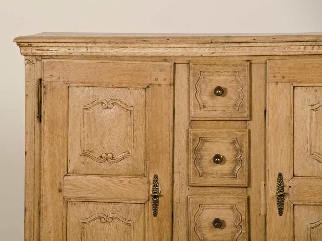 Receive our new selections direct from 1stdibs by email each week. Please click Follow Dealer below and see them first!

A Régence period antique French pale oak buffet with four drawers, circa 1730. The unusual height of this cabinet and the