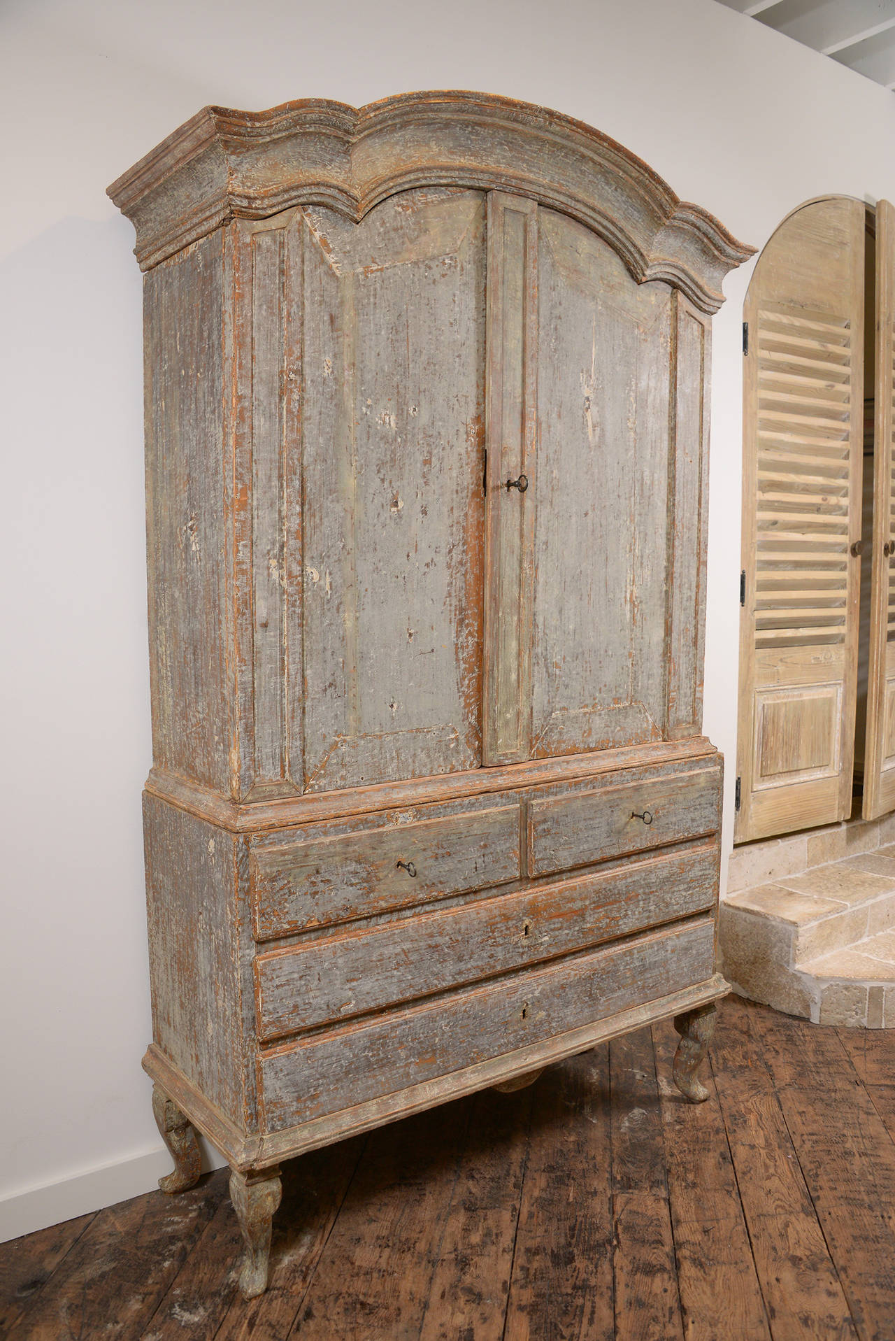 Handsome Swedish 18th century Rococo cabinet in original paint. Very elegant, elongated foot.  One of the best cabinets we have seen at M Naeve.