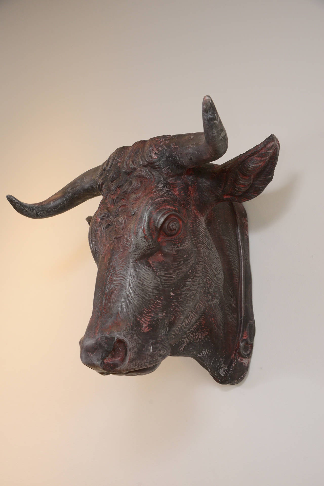 French iron bull head from the 1900's.  This figure has remnants of the original red paint.  In great condition. The butcher's trade sign.