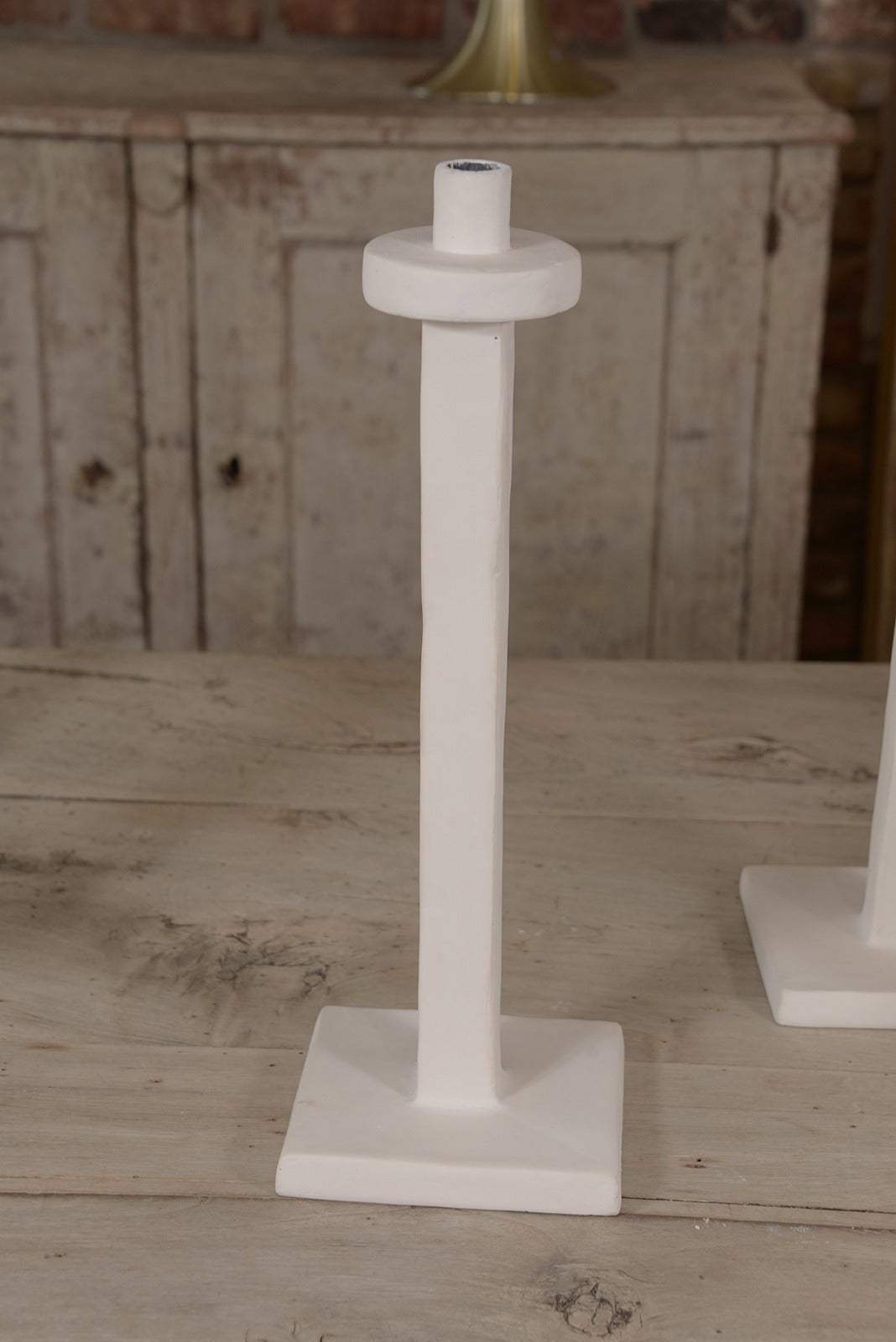 Decorative plaster candlesticks made in France, a variety of sizes available. There are four 18 inches tall and five 23 inches tall.