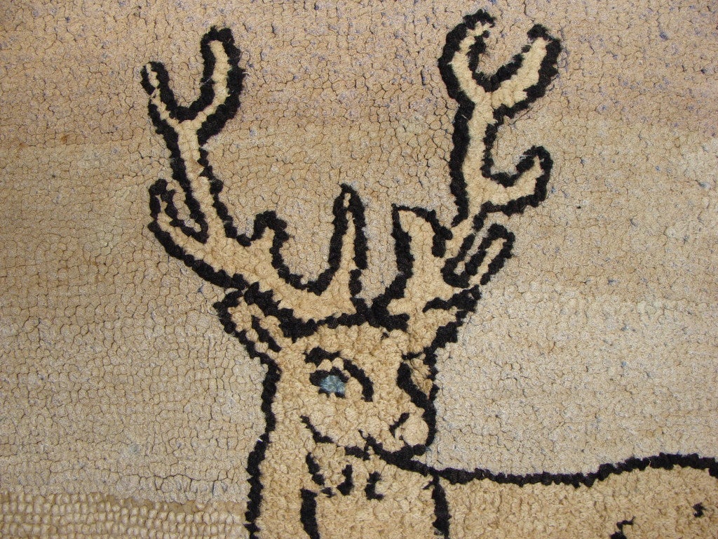 A beautiful hooked rug with pictorial scene featuring a highly expressive stag with soft tonal blues and greens.