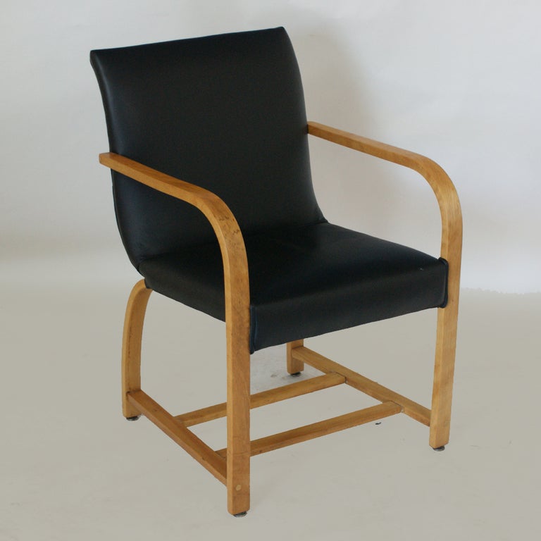 A set of eight Art Deco dining chairs designed by Gilbert Rohde in 1931 and made by Heywood Wakefield. Two armchairs and six side chairs. Similar chairs are in the Cooper Hewitt Design Collection. Bentwood maple frames with black leather upholstery.