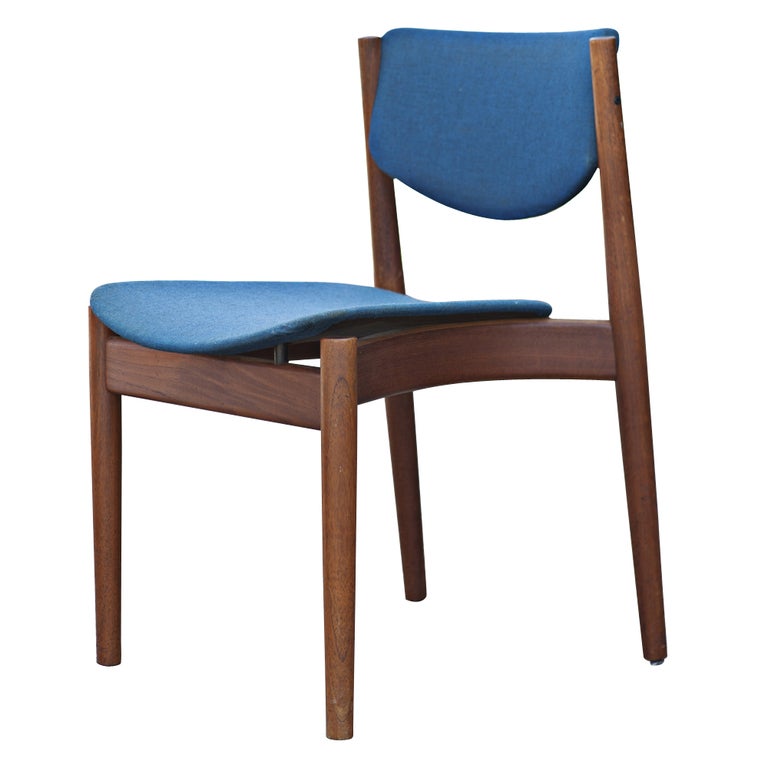 A set of four mid century modern dining chairs designed by Finn Juhl and made by France and Son.  Model 197 with teak frames and upholstered seats and backs.
