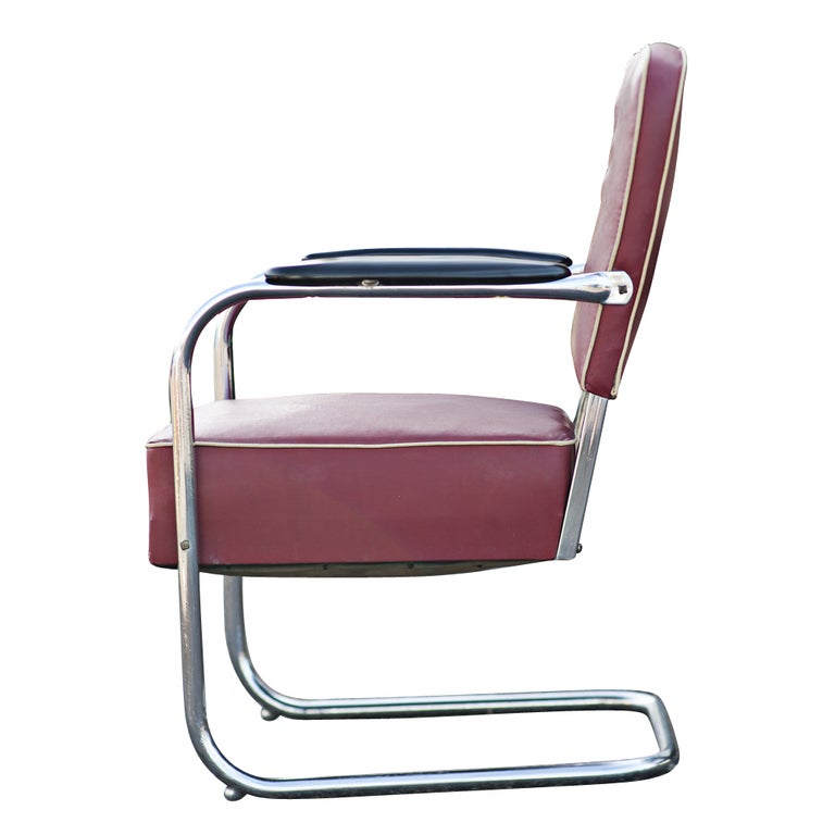 A pair of Art Deco Royal Chrome lounge chairs made by Lloyd. Chrome frames with the original maroon vinyl upholstery with white welting and wooden armrests.