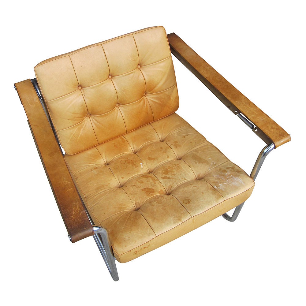 These are leather and chrome lounge chairs designed by Swiss architect Kurt Thut and made by Stendig in Switzerland in the 1970s. Chrome tubular frame and adjustable leather straps feature a unique spring tension arm strap. The chairs are