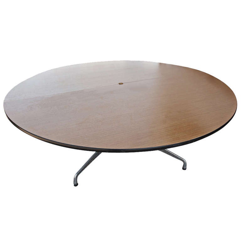 Classic Eames Aluminum group table with segmented base. Table features a red wood oak veneer top with two-piece top construction.