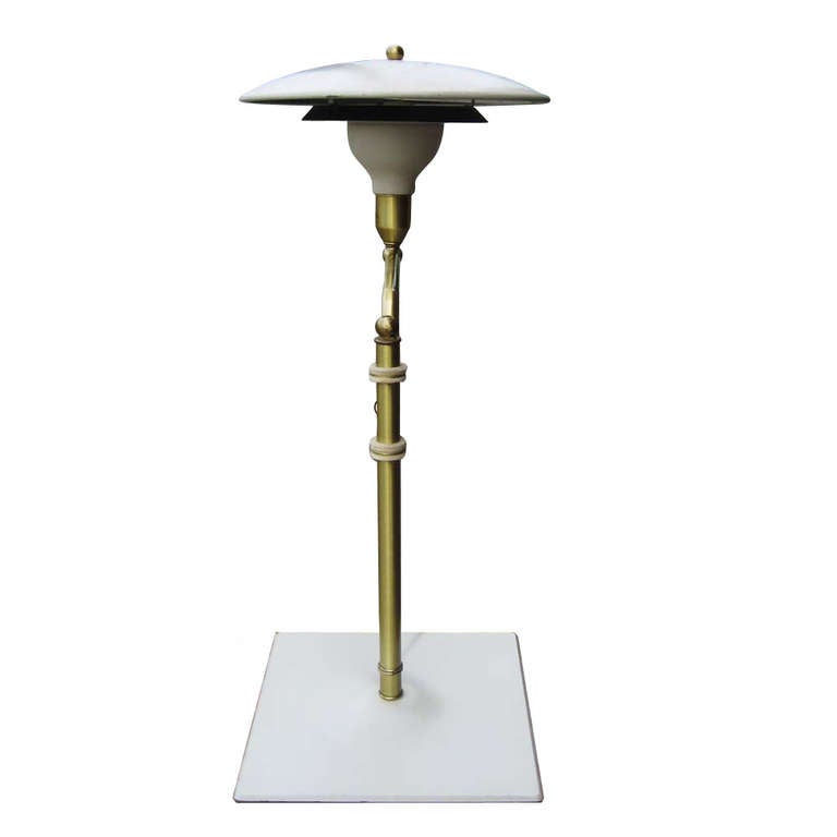 Here is an attractive light for your desk, nightstand or table. The lamp has great Art Deco styling and is a nice manageable size.

The dome, supported by a gracefully curved arm, reflects the light downward toward your work and shades your eyes