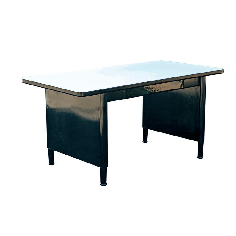 A mid century modern steel desk or work Panel leg desk table which has been completely restored.  Newly powder coated in black with a new white laminate top.