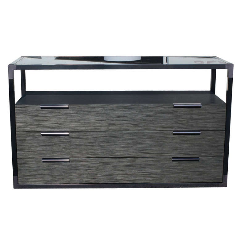 Ligne Roset Contours entertainment center/sideboard cabinet with glass top. Very clean-lined, modern design featuring three spacious drawers. Top glass included. 
 
Matching three door cabinet also available. Please inquire.