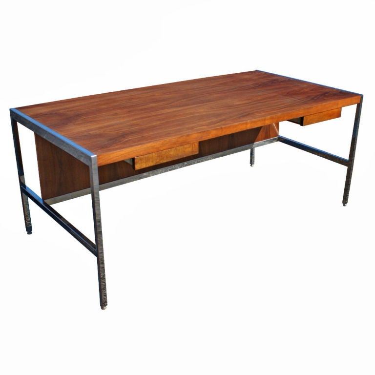 A mid century table desk made by Jasper.  A rosewood case with chrome frame and legs and two regular drawers.  As shown in the last image we also have a matching credenza in walnut.