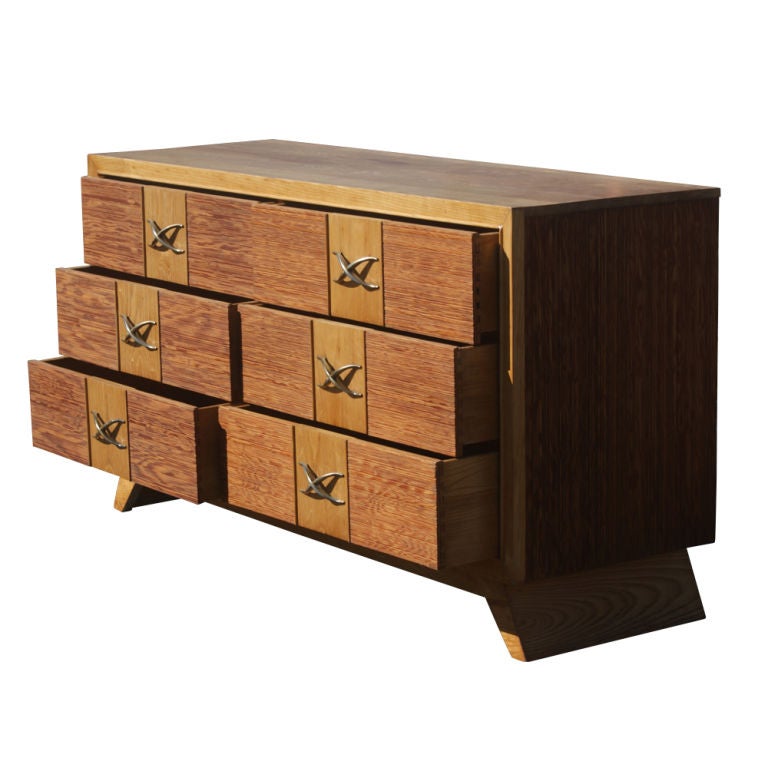 A mid century modern dresser or chest designed by Paul Frankl and made by Brown Saltman.  An oak case and top with drawers and sides accented with bamboo.  Six drawers with Paul Frankl's well known brass X hardware.