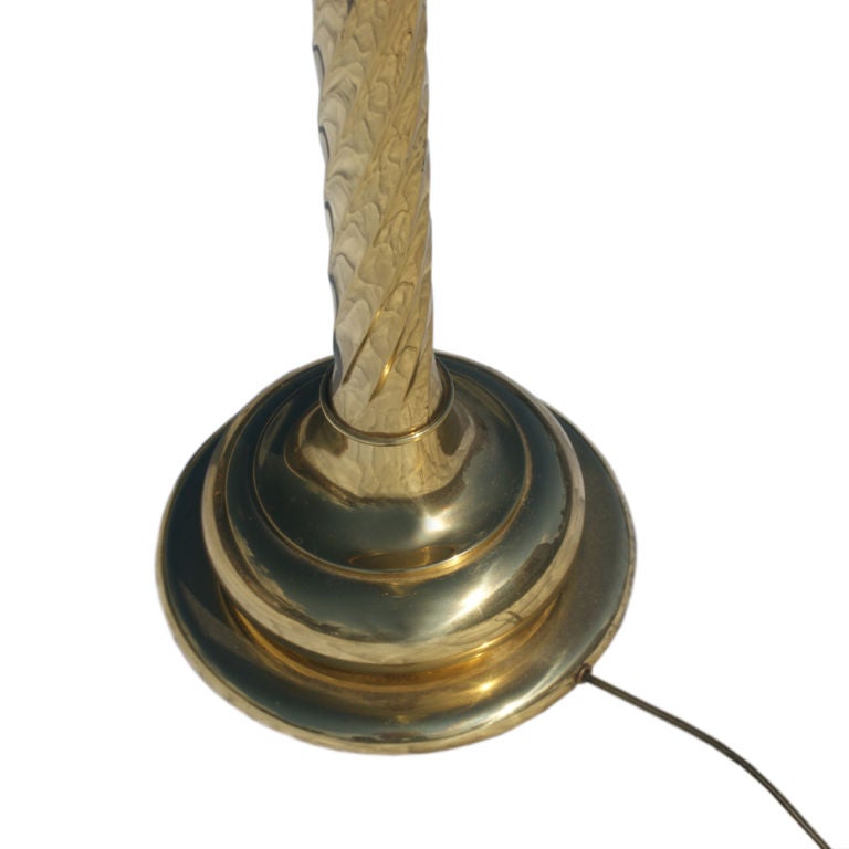 An elegant brass floor lamp made by Stiffel.  Twin sockets with original ball pull chains and finial.  Original shade included.