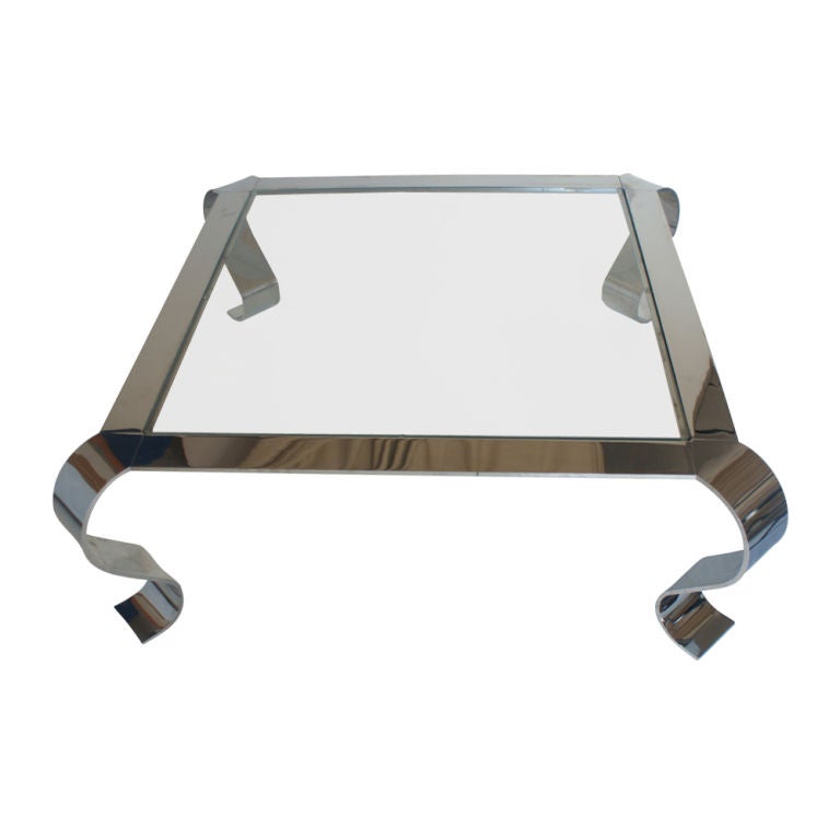 An elegant mid century modern square coffee table. Chrome frame with curved legs and glass insert top.