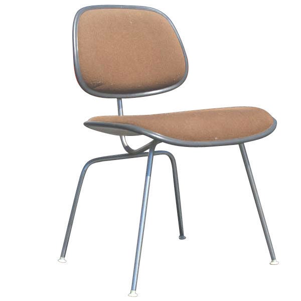 A set of four mid century modern DCM dining or side chairs designed by Charles and Ray Eames and made by Herman Miller.  Metal frames with plastic shell seats and backs upholstered in tan fabric.
