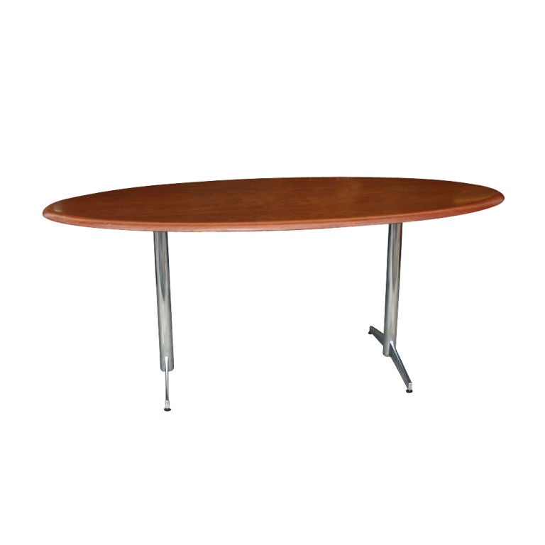 A mid century modern table or desk made by Stow Davis.  A chrome double pedestel base with an oval top.
