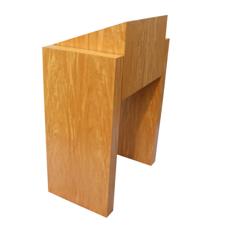 A heavy and high quality custom made lectern in curly maple with a storage compartment.