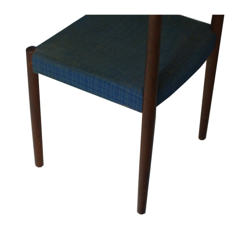A pair of mid century modern side chairs designed by Nils Jonsson and made by Troeds Bjärnum.  Beautifully grained rosewood frames with blue fabric upholstery.