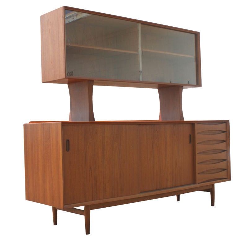 A mid century modern teak china cabinet or sideboard designed by Arne Vodder and made by Sibast in Denmark.  A classic design part of the collection of the Danish Museum of Art and Design.  The lower section with six drawers and two sliding doors