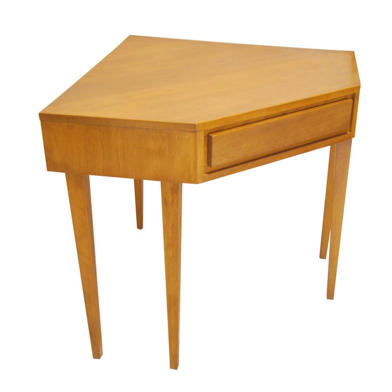 A mid century modern corner desk designed by Russell Wright and part of Conant Ball's Modernmates series.