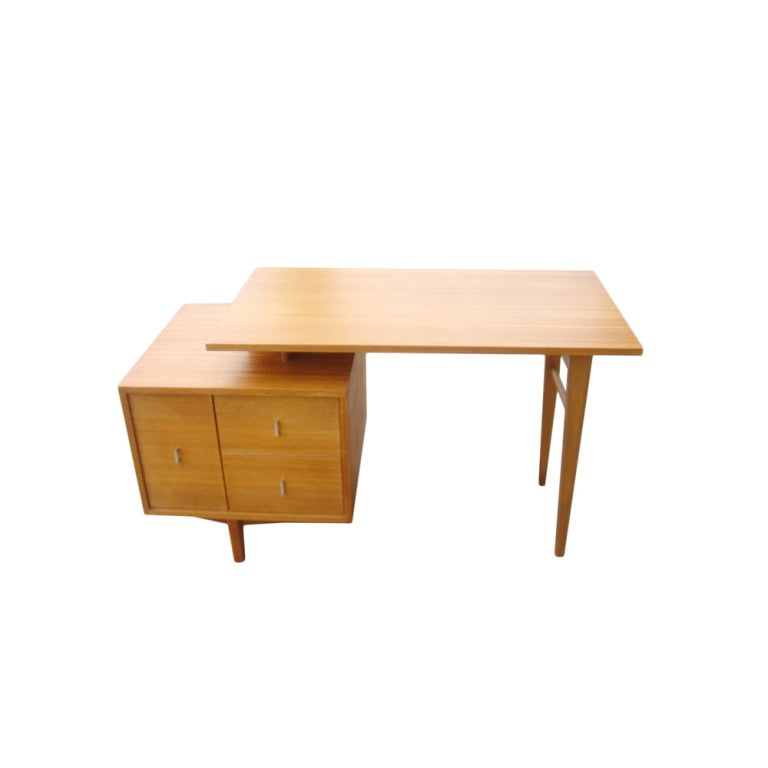 A mid century modern cerused mahogany desk designed by John Keal and made by Brown Saltman.  A floating top supported by three drawers on one side and tapering legs on the other.  The front has an open shelf.  A wonderful example of mid-century