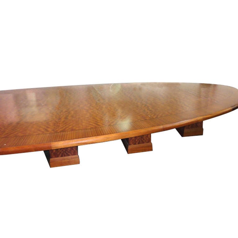 An exceptionally large conference table with an oval top and base with five pedestals.  The top is a beautiful burl.
