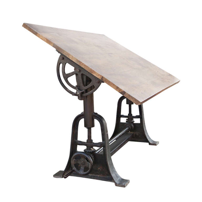 A wonderful and unusual adjustable industrial drafting table with a 1