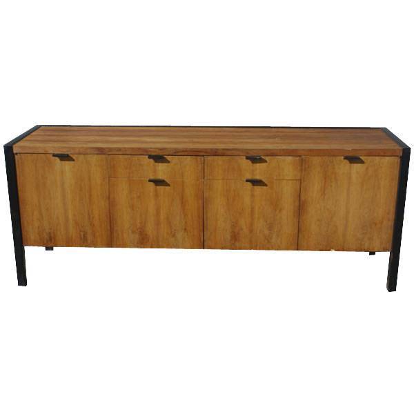 A mid century modern credenza designed by George Nelson and made by Herman Miller.  An ebonized wood frame and back with a rosewood case.  Four drawers, including two file drawers, and two doors concealing shelved storage.