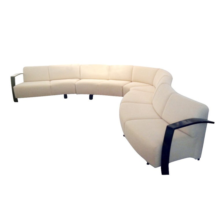 A Modern Sectional Sofa by Thonet 

Four separate sections providing for different serpentine configurations.  Ebonized wooden arms and feet.  Newly upholstered in a textured cream colored fabric. 

See complete measurements in last photos: