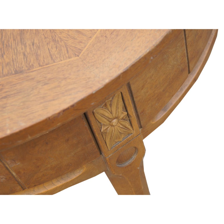 A traditional round side table made by American of Martinsville.  Constructed of walnut with a nicely patterned top and burled side panels.