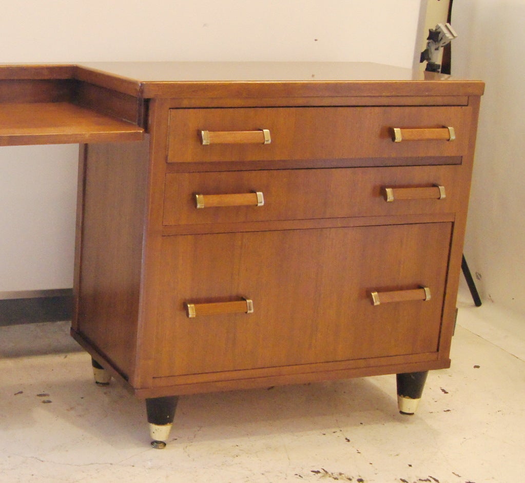 A mid century modern walnut credenza with wood grain laminate top.  Three drawers including one file drawer.  We also have a matching desk listed on 1stdibs as shown in the last image.