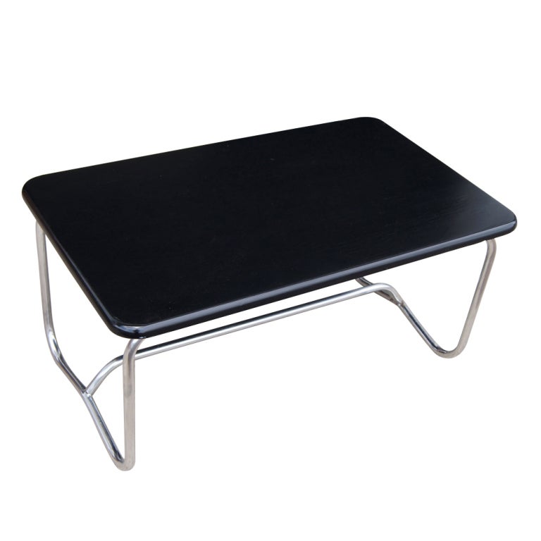 An Art Deco coocktail or coffee table designed by Alfons Bach and made by Lloyd Loom.  Tubular chrome base with original black top.