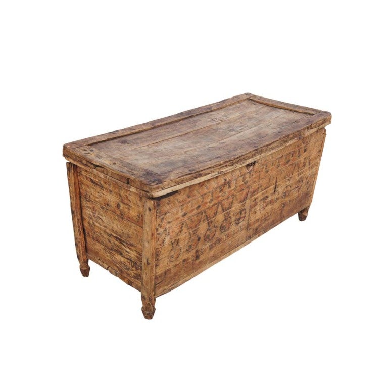 A rustic wooden Moroccan style chest or trunk with painted decoration which could also be used as a coffee or cocktail table. A hinged lid for storage access.