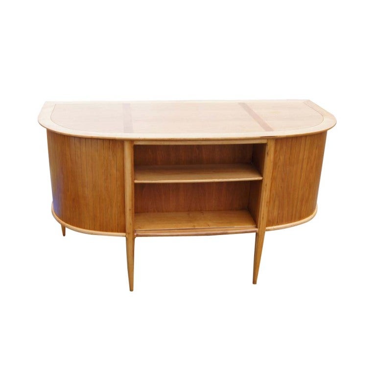 A mid century desk from Tomlinson's Sophisticate series designed by John Lubberts and Lambert Mulder.  A curved paneled front with two bookshelves and six drawers including one file drawer.