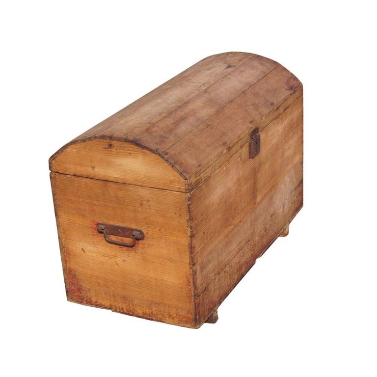 A rustic chest made in Morocco with a removable lid and metal hardware.