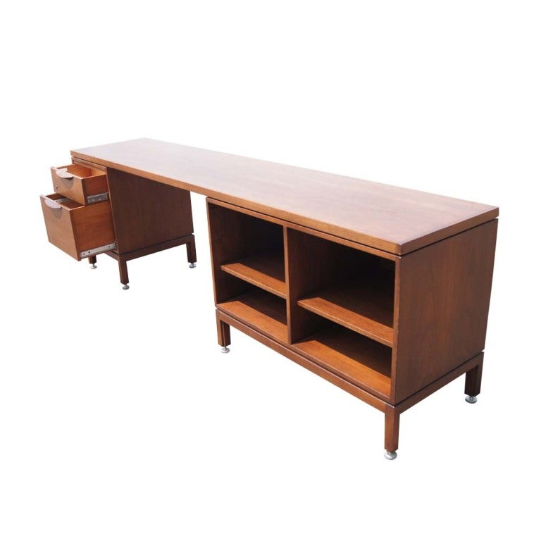 A mid century modern kneehole credenza designed by Jens Risom and made by Jens Risom Design.  Two drawers and open shelving.