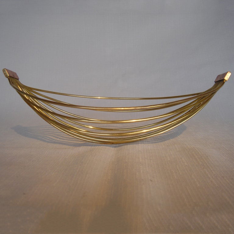 A mid century modern fruit basket designed by Carl Aubock.  Brass rods with hammered copper handles.Signed with a stamp 