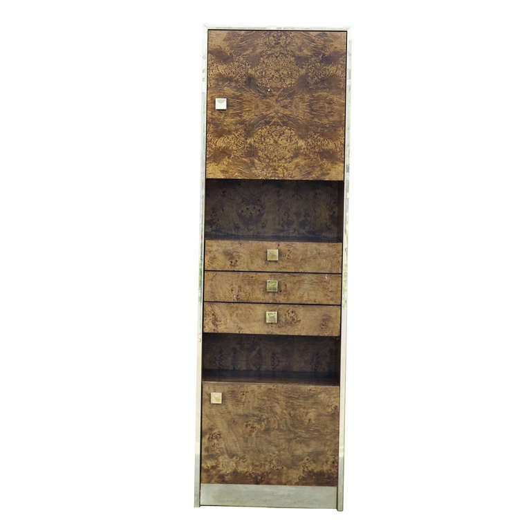 A burled wood cabinet from Thomasville. This piece has two cabinet doors, metal pulls, a gorgeous burled exterior, one cabinet is shelved and the other open. Two nook spaces and three drawers contribute to make this a great utiliser of your