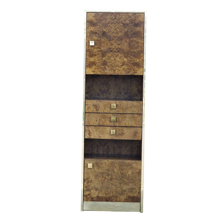 A burled wood cabinet from Thomasville. This piece has two cabinet doors, metal pulls, a gorgeous burled exterior, one cabinet is shelved and the other open. Two nook spaces and three drawers contribute to make this a great utiliser of your